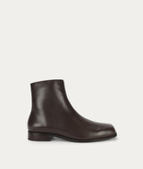 Brown leather ankle boot on a light gray background
